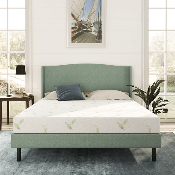 A bed with a NapQueen Mattress in a room with a picture on the wall. Anula green tea mattress