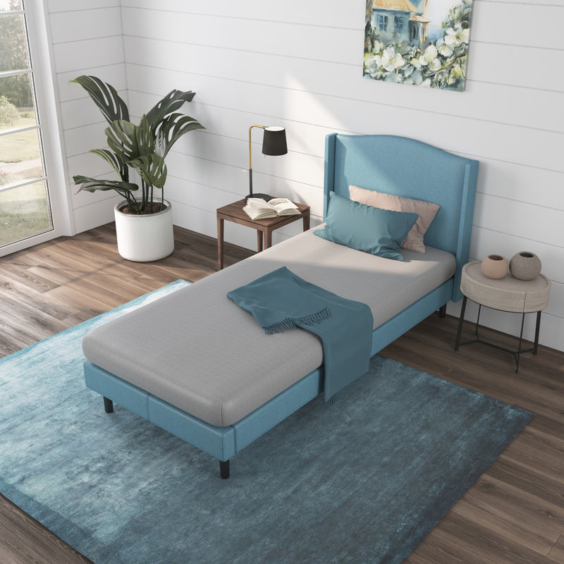 a bed with a blue kids mattress in a room