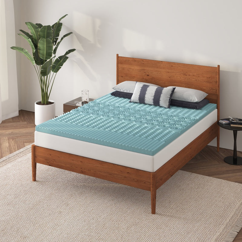 a bed with a mattress topper