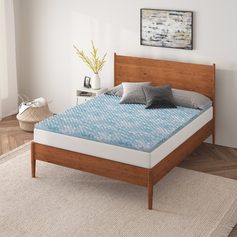 a bed with a blue mattress topper